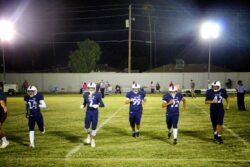 5 football players on a field