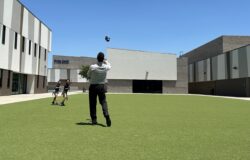 teacher playing catch with students