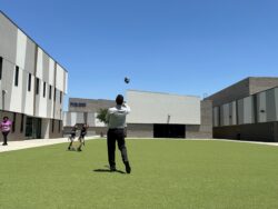 teacher playing catch with students